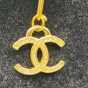 Stamped CHANEL Gold Crystal Charm
